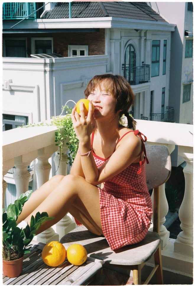 Asian lady sitting outside on balcony